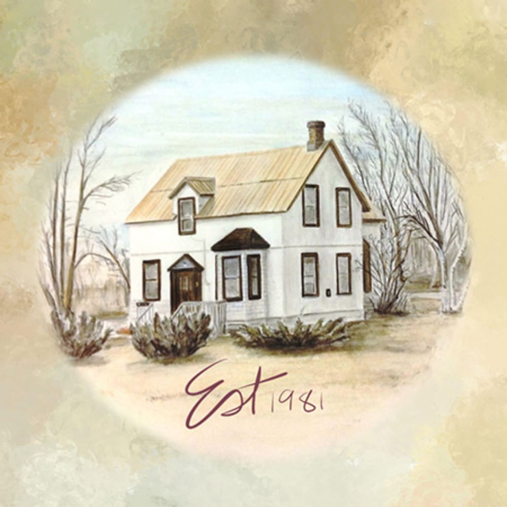 Happy and laughing senior couple resting along a forest trail with their large dog.